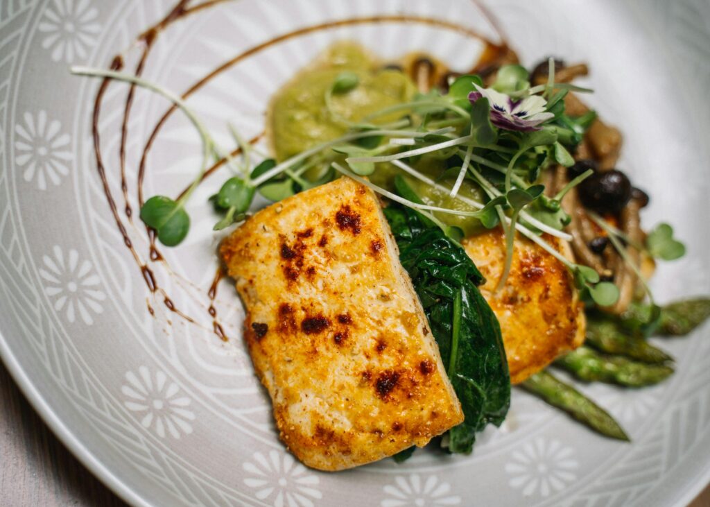 Delicious grilled tofu served with sautéed vegetables and microgreens.